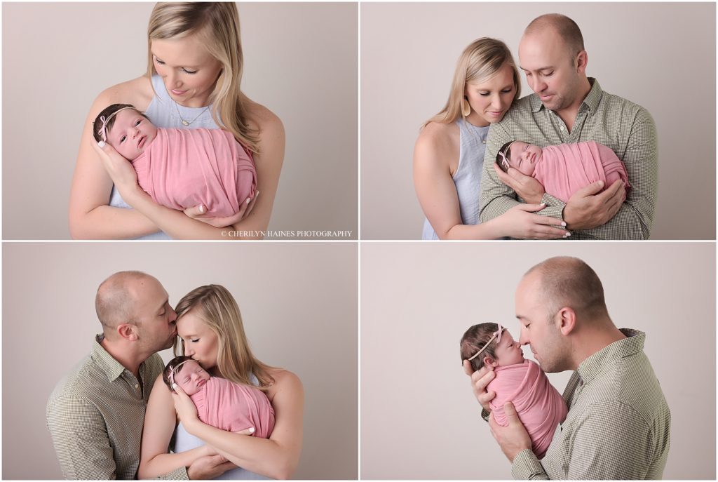 newborn baby girl photographed with mom and dad
