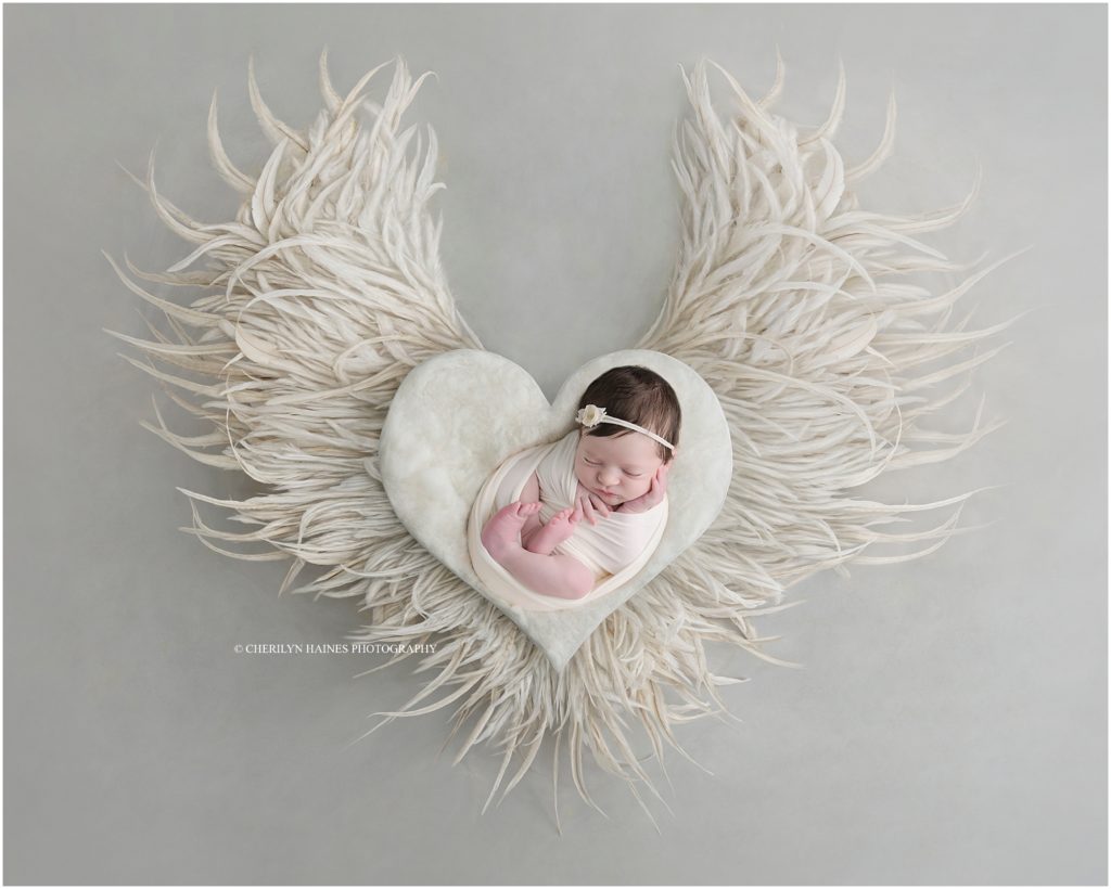 newborn portraits in Baton Rouge, Louisiana with Cherilyn Haines Photography; baby photographed with large white angel wings