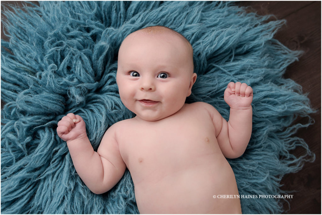 4 month old baby boy photographed on teal fuzzy rug; cherilyn haines photography
