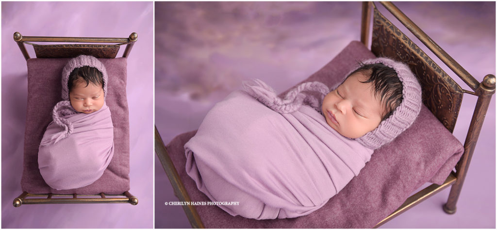 newborn baby girl photographed in tiny bronze bed