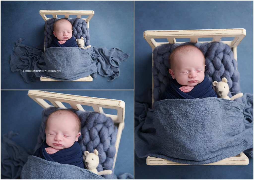 cherilyn haines photography; newborn baby boy laying in tiny wooden bed holding teddy bear