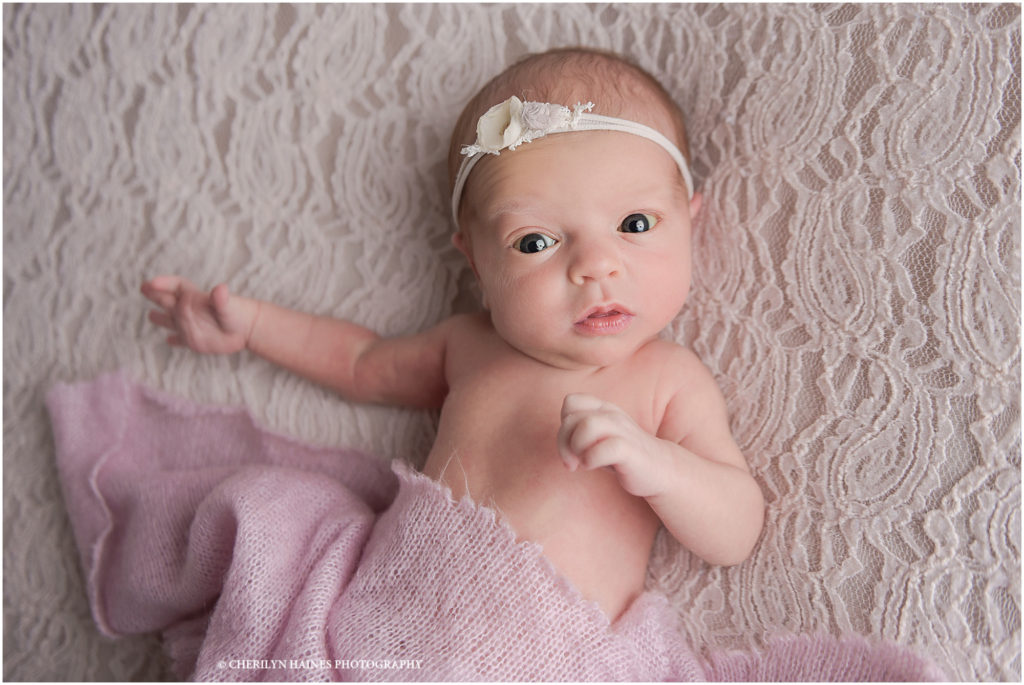 12 day old baby girl photographed on cream lace blanket