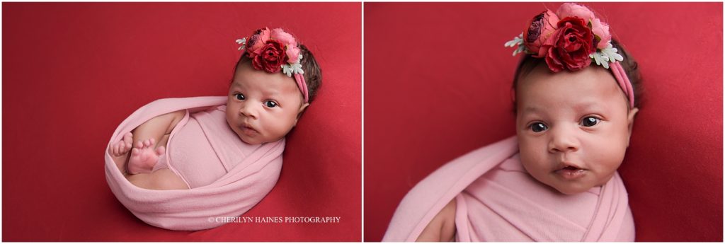 1 month old baby girl photographed on red blanket