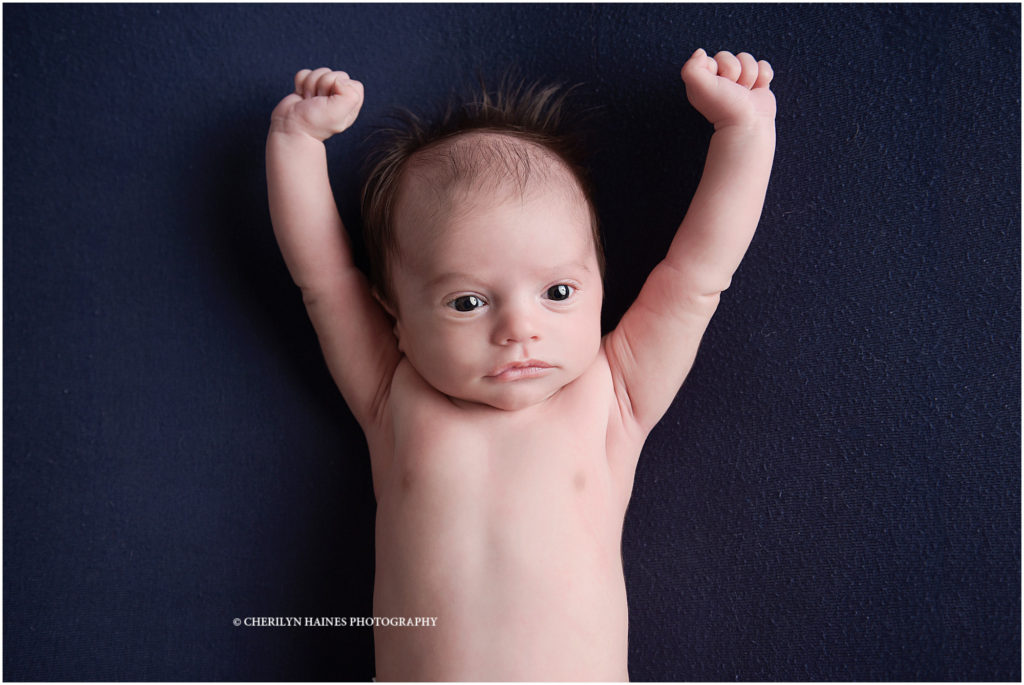 6 week old newborn baby boy portrait; baby stretching arms